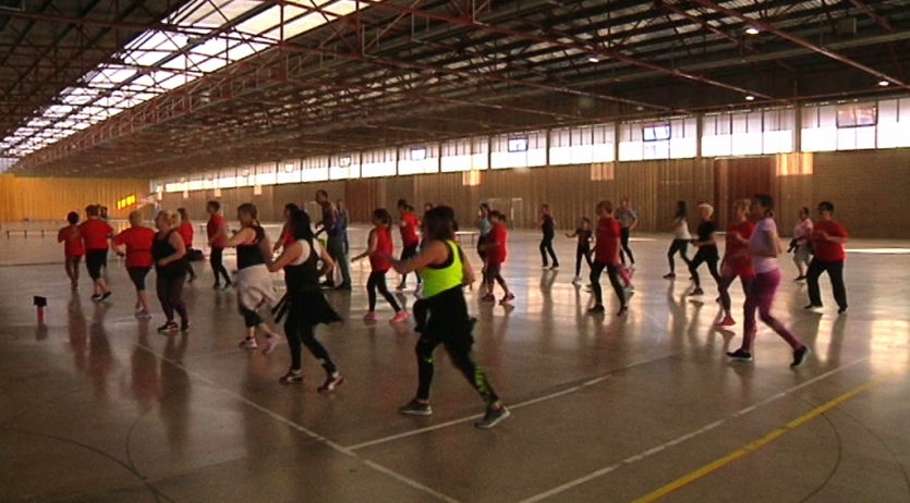 Desenes de persones assisteixen a la masterclass benèfica de zumba organitzada per ADAP